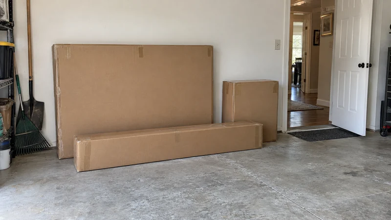Show where the previous delivery stopped Manufacturer furniture cartons in a garage with a clear route toward the receiving room