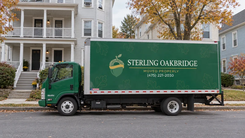 A green NPR moving truck beside representative Worcester wood-frame homes A green NPR moving truck beside representative Worcester wood-frame homes