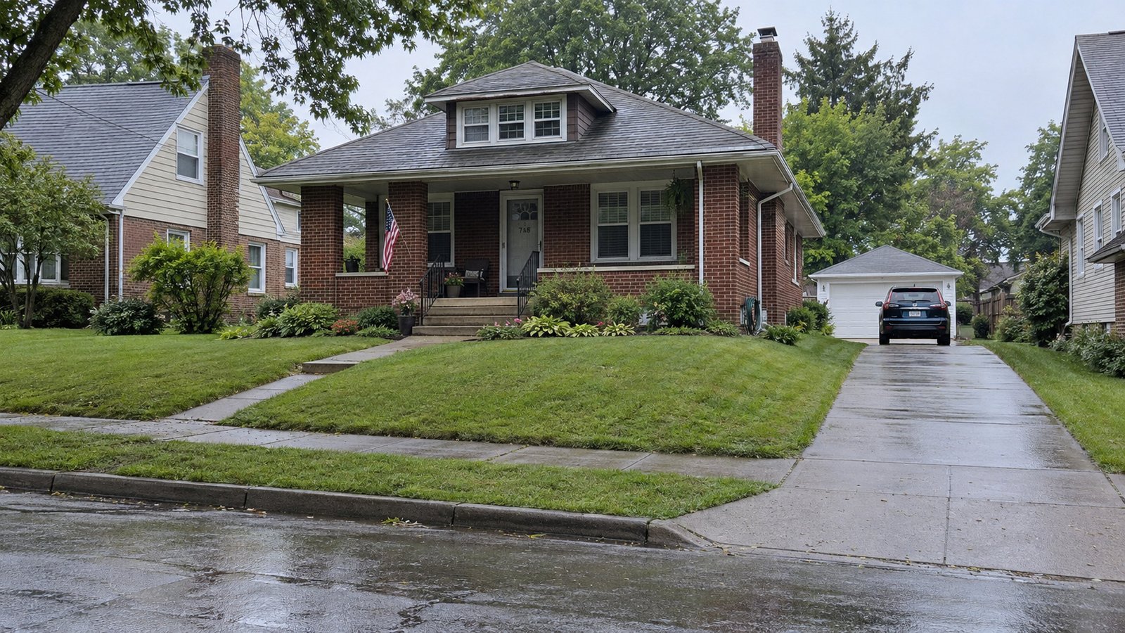 Brick bungalow, driveway and detached garage Brick bungalow on a raised lawn with porch steps, a side driveway and a detached garage