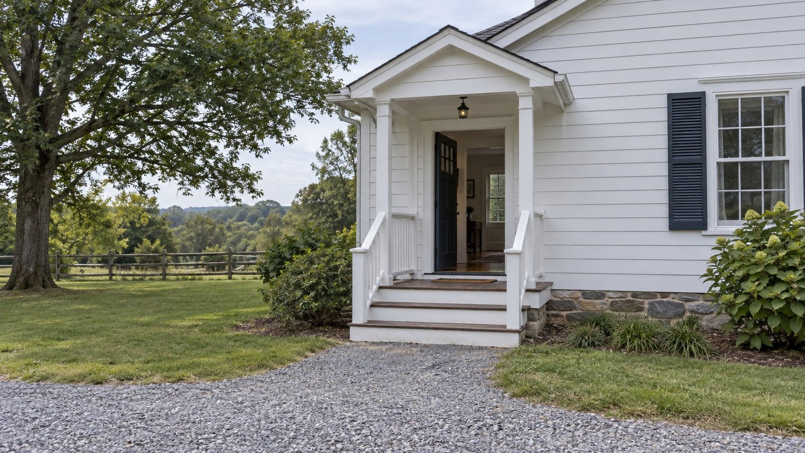 Inspect the final entrance A complete timber porch entrance with broad steps, landing and a visible doorway into a farmhouse.