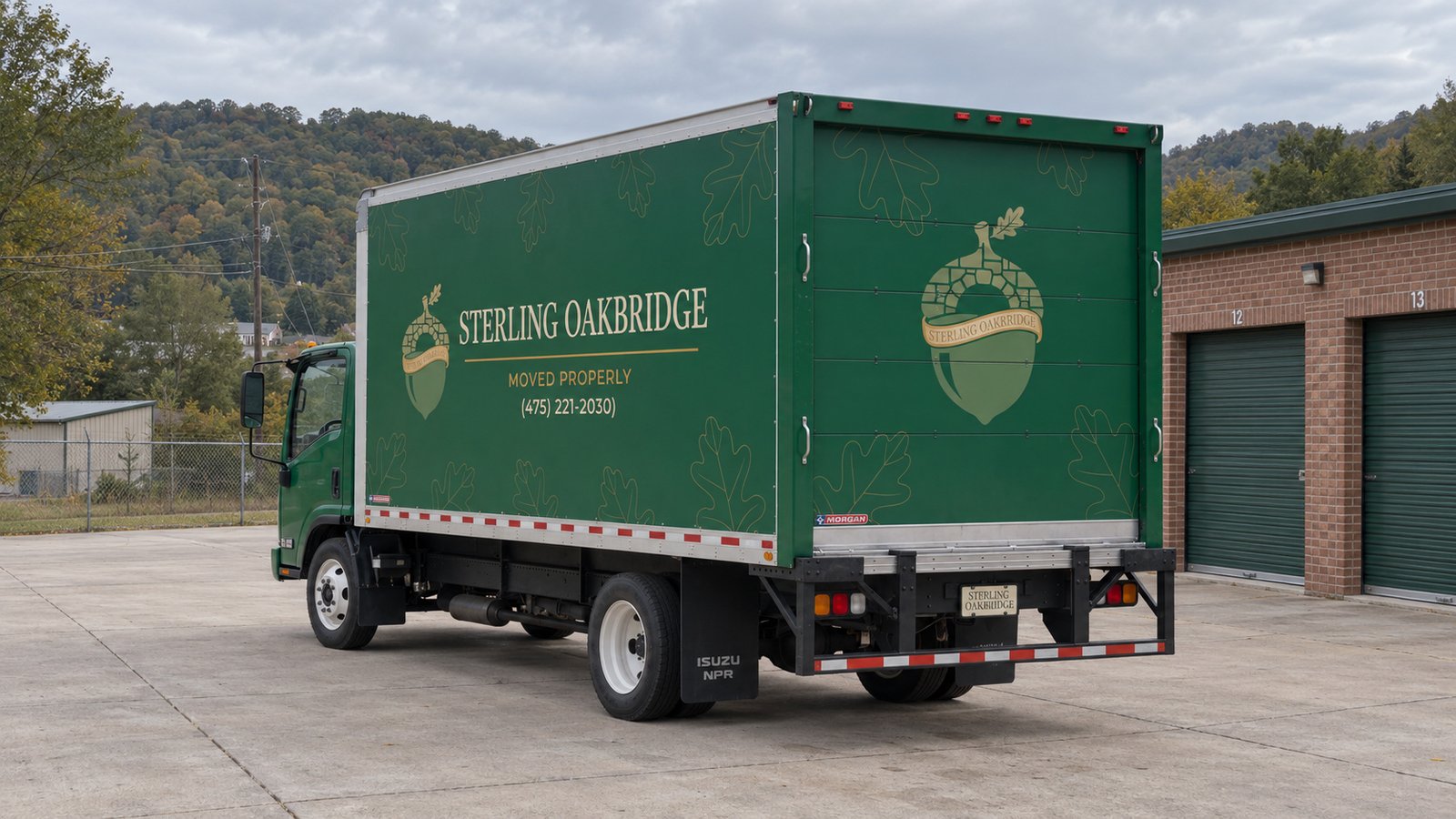 Standing space for a storage delivery A complete green Sterling Oakbridge truck on a concrete apron beside storage units