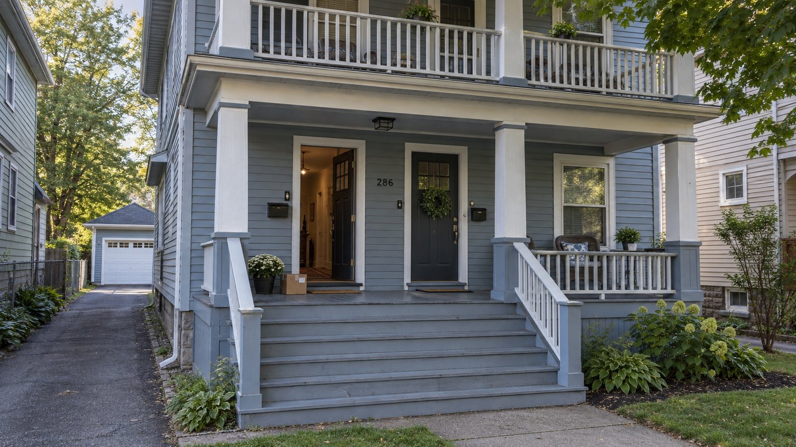 A wood-frame Buffalo double with a shared front porch and a narrow side driveway.