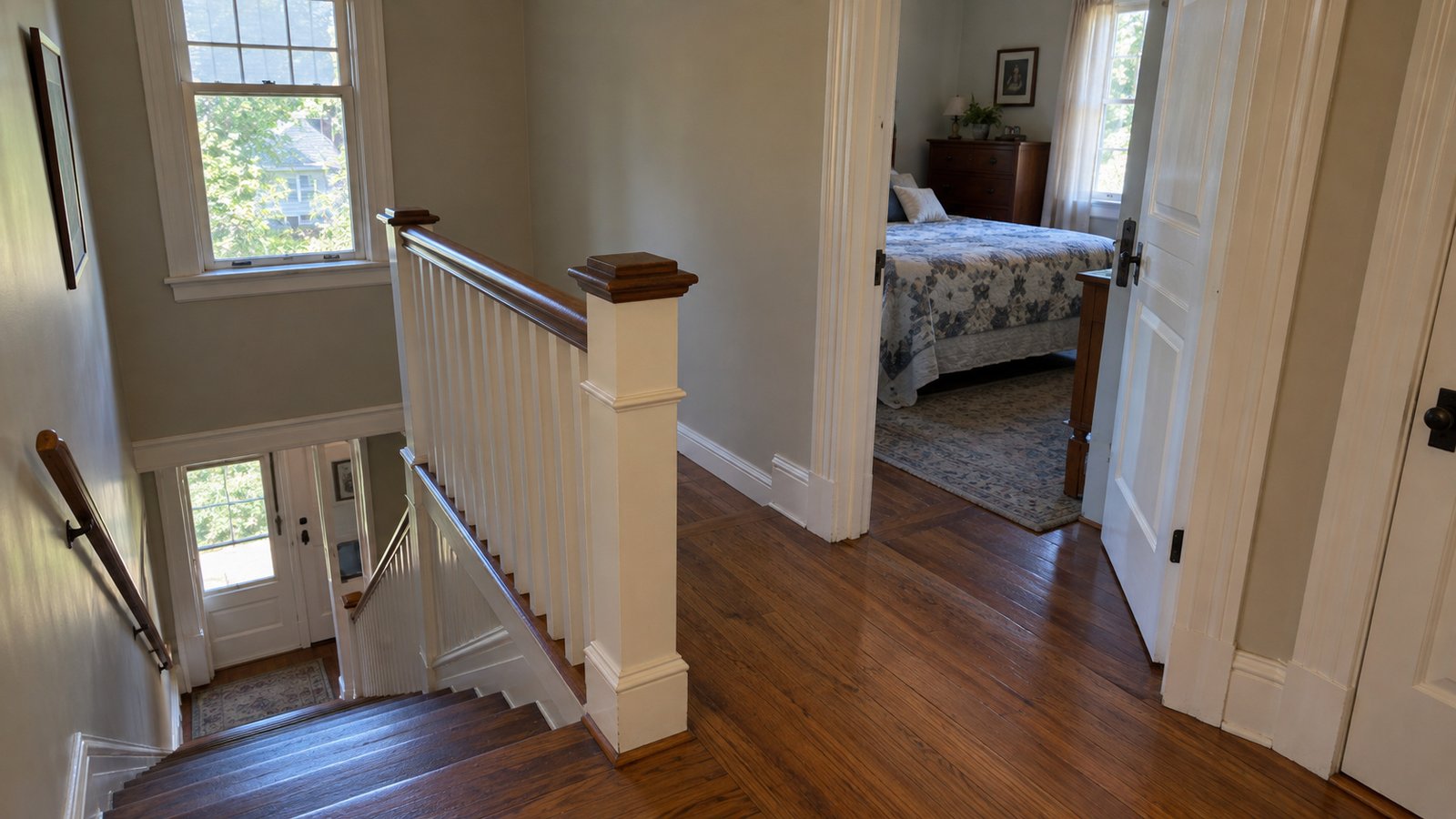 The turn from a landing into a bedroom Wooden upstairs landing with a stair balustrade, open bedroom doorway and a clear turn between the two