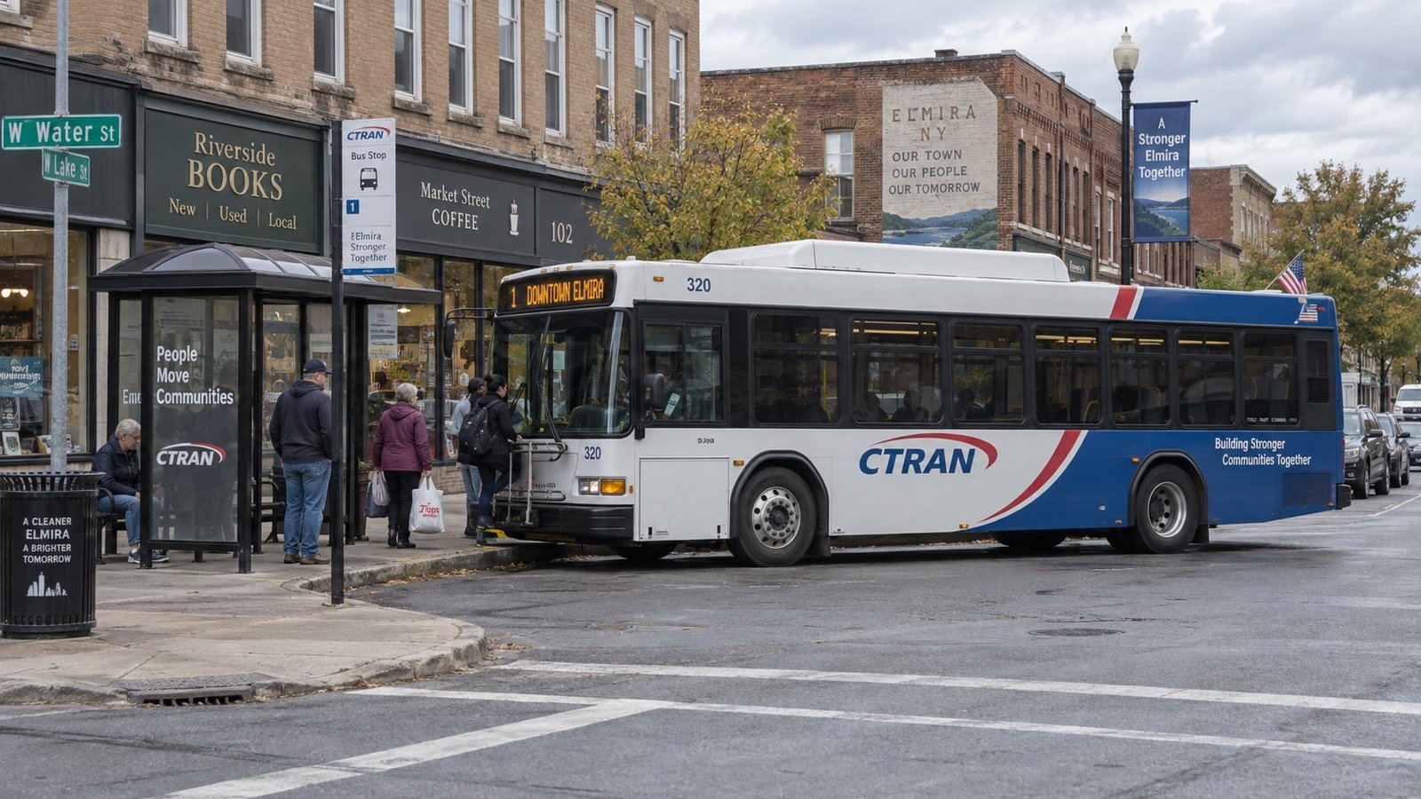 A small-city street with a local bus among older commercial buildings.
