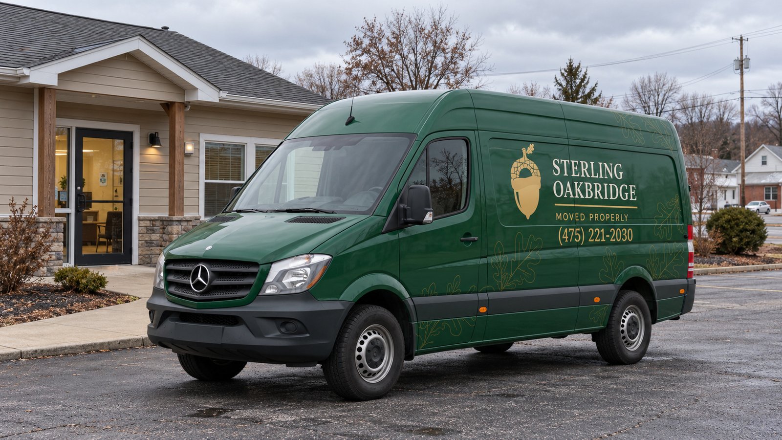 Vehicle position beside an entrance Green Sterling Oakbridge Mercedes Sprinter van on a paved forecourt beside an office entrance and separate walkway