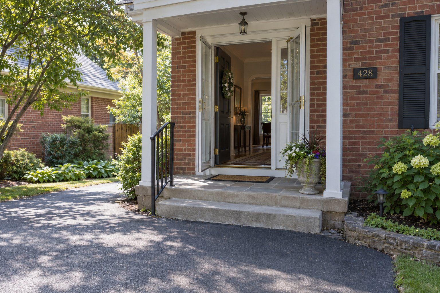 Inspect the entrance and steps An open brick-home doorway with both leaves, two shallow steps, threshold and a furnished hall beyond.