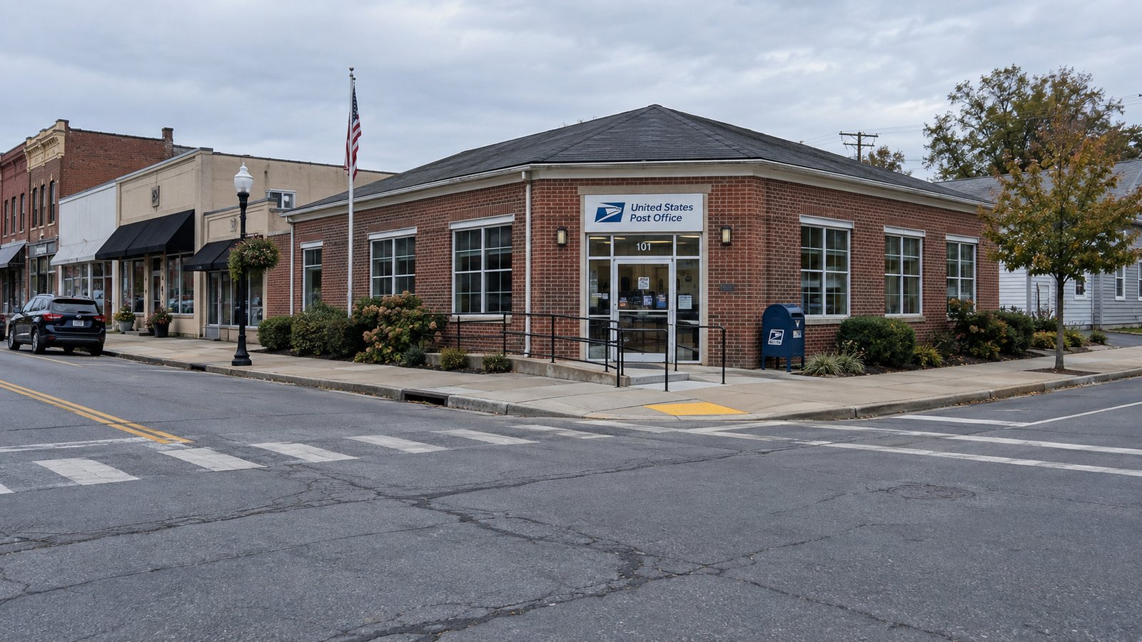 One-story brick post office on an American street corner with a sidewalk and curb ramp