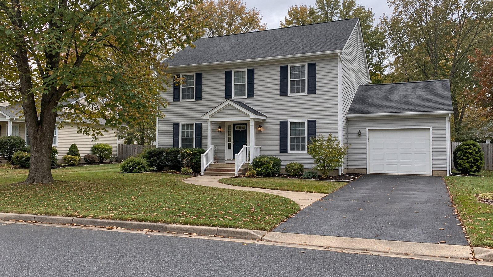 Two-story siding home with a connected driveway and curved path to the front porch Two-story siding home with a connected driveway and curved path to the front porch