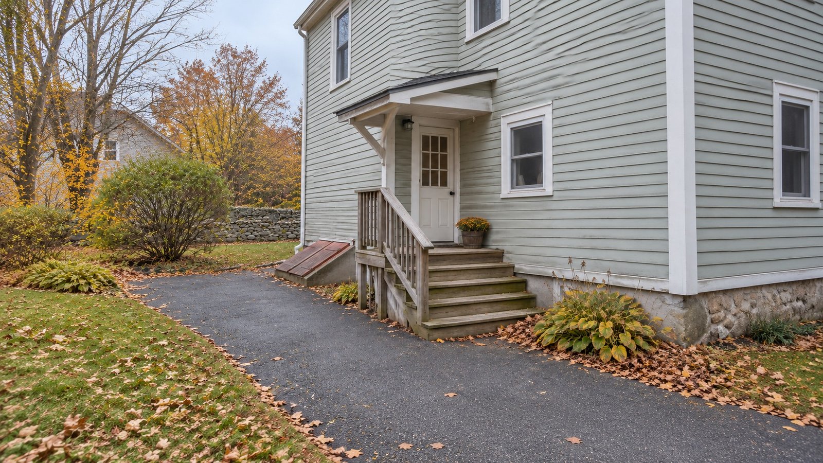 Follow the actual delivery entrance A complete rear doorway, small shelter, wooden landing and steps connected to a clear paved path.