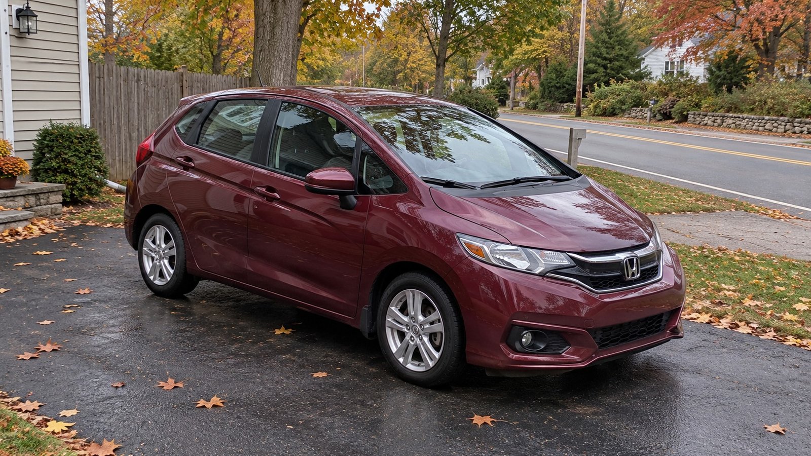 Test an ordinary journey A complete ordinary compact car parked in a private drive beside a continuing residential road.