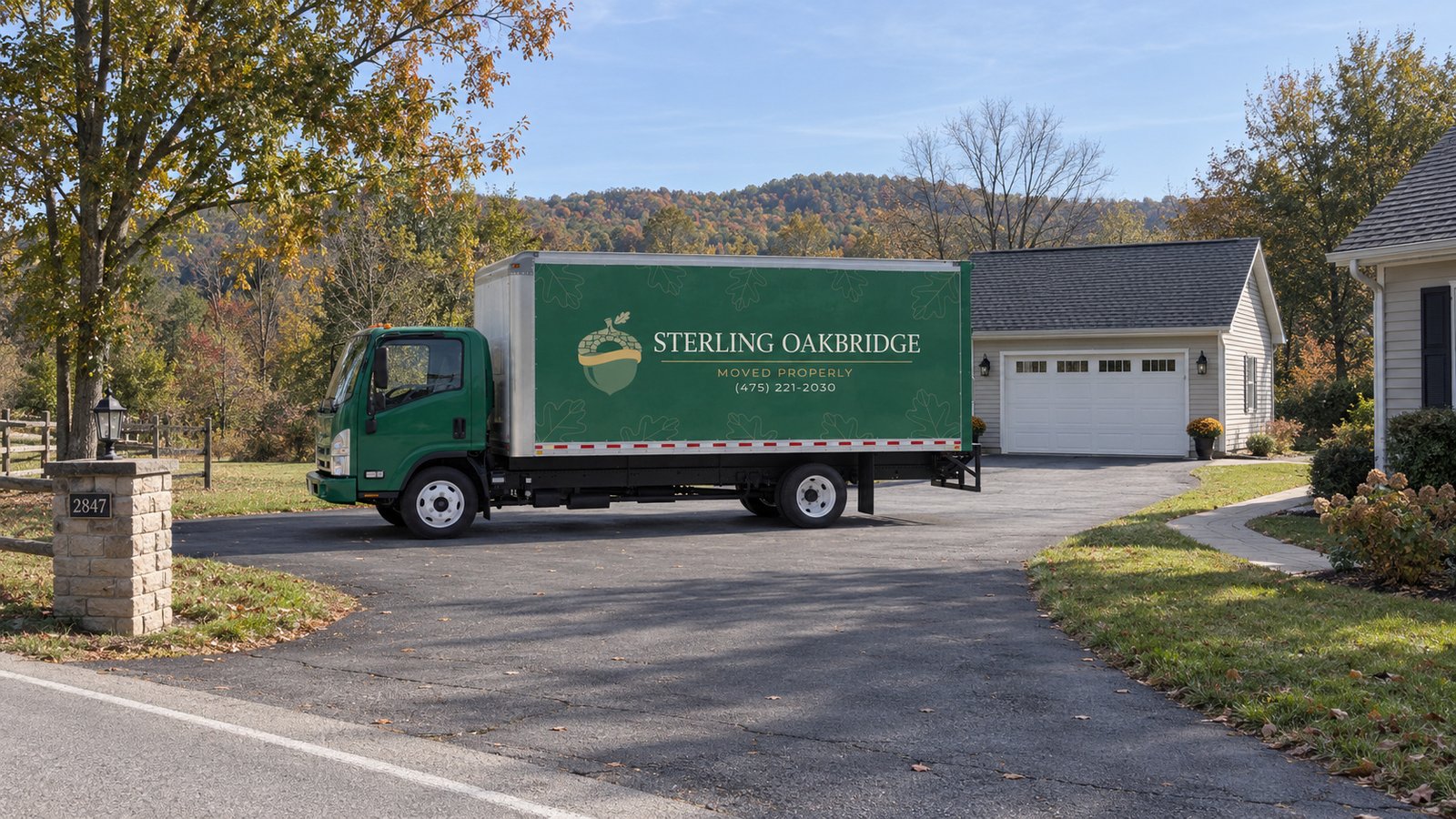Assess the proposed truck position A complete green Sterling Oakbridge Isuzu NPR20 truck on a paved driveway beside a garage.