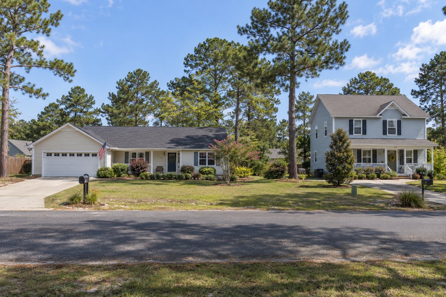 Inspect the property approach Two complete principal ranch and colonial houses beside pine-lined private driveways.