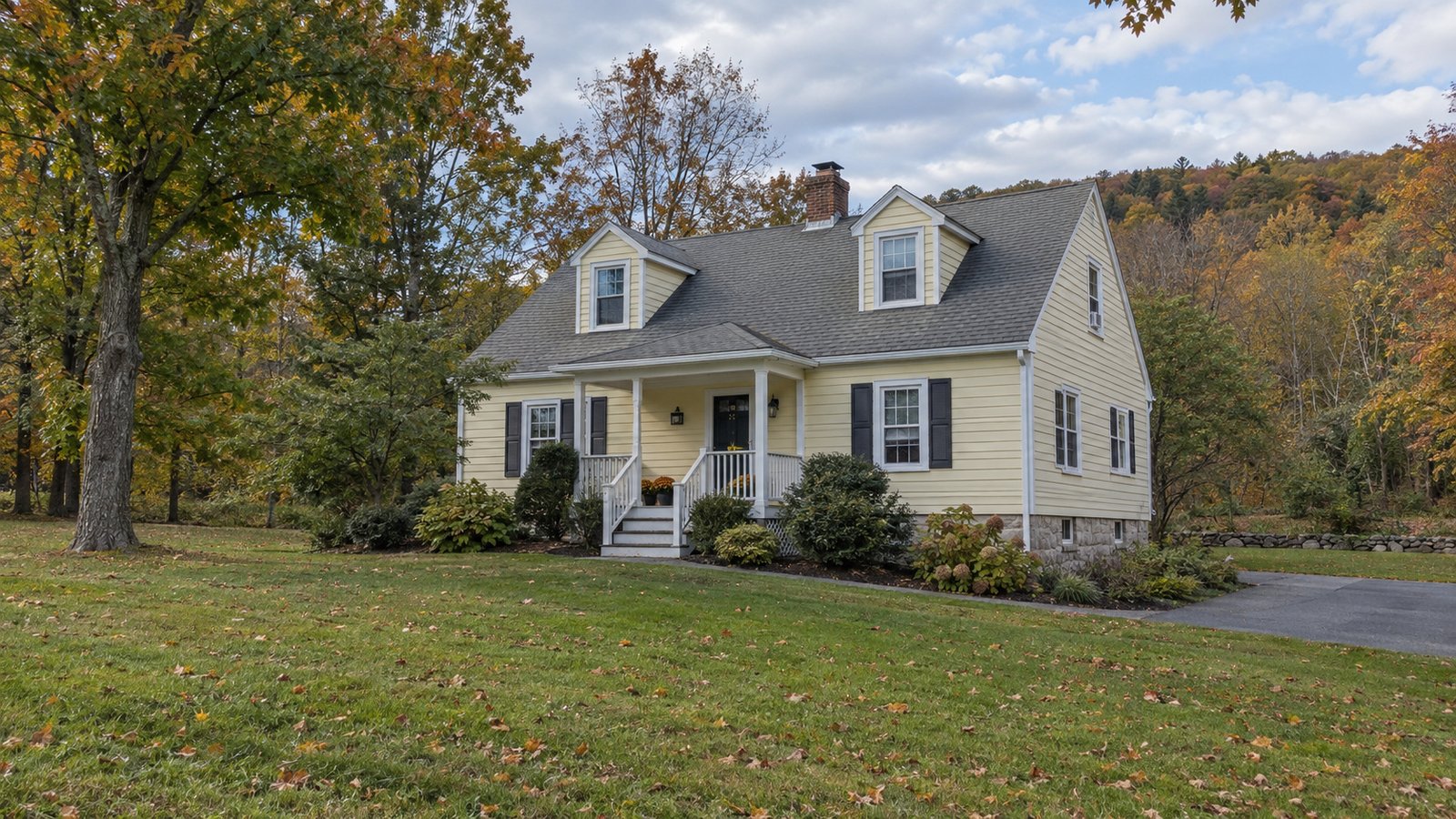 Plan the receiving property A whole pale-yellow cape-style house with two dormers, a covered porch, granite foundation and paved drive.