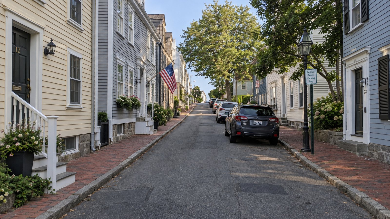 Planning a Newport residential move Clapboard houses and brick sidewalks along a narrow street with parked cars