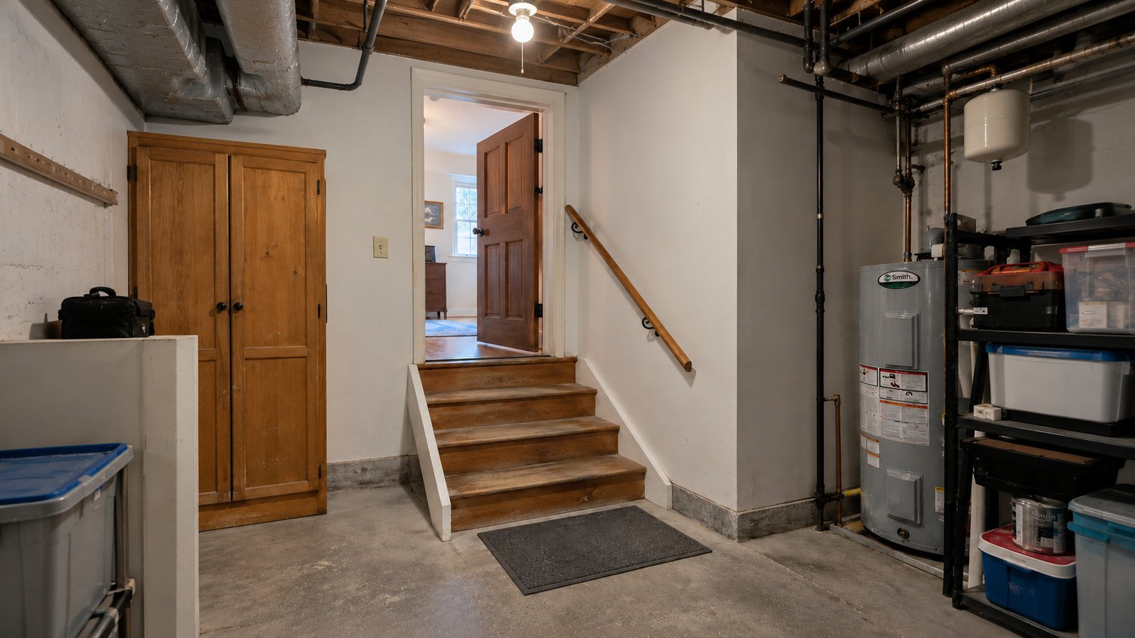Interior steps to a lower-level room Four wooden steps, an open upper door and a handrail leading into a utility room