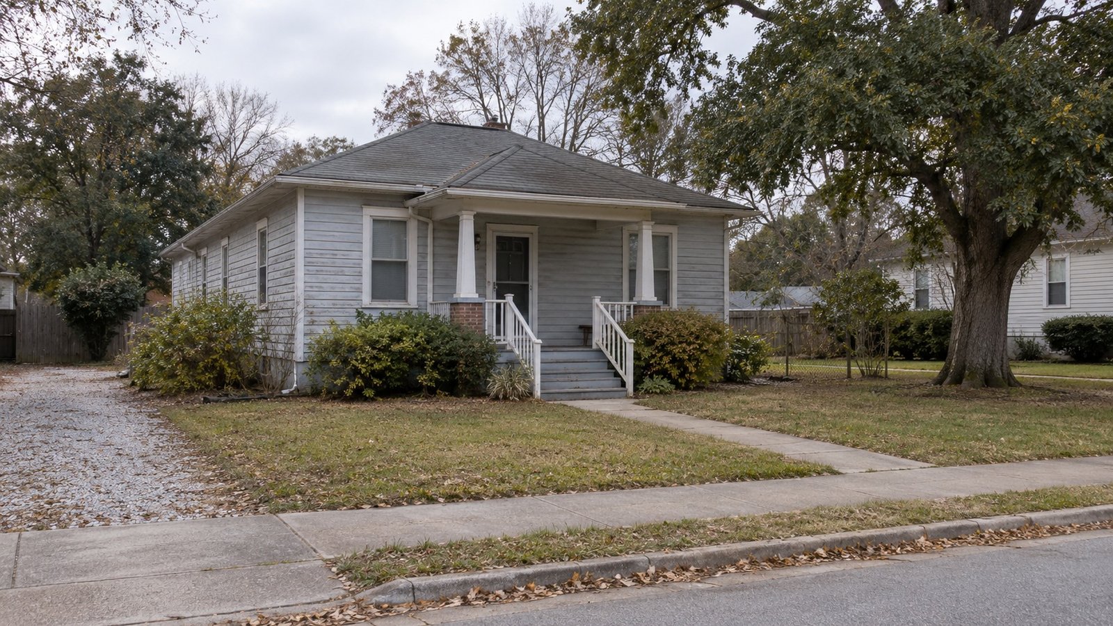 See the home and its approach A complete modest house and its ordinary raised front entry.