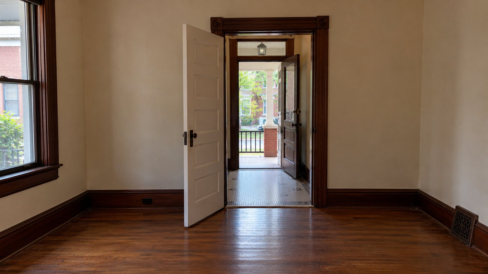 Review successive entrance doors together An open inner doorway leads across a tiled vestibule to an open exterior door and raised porch.