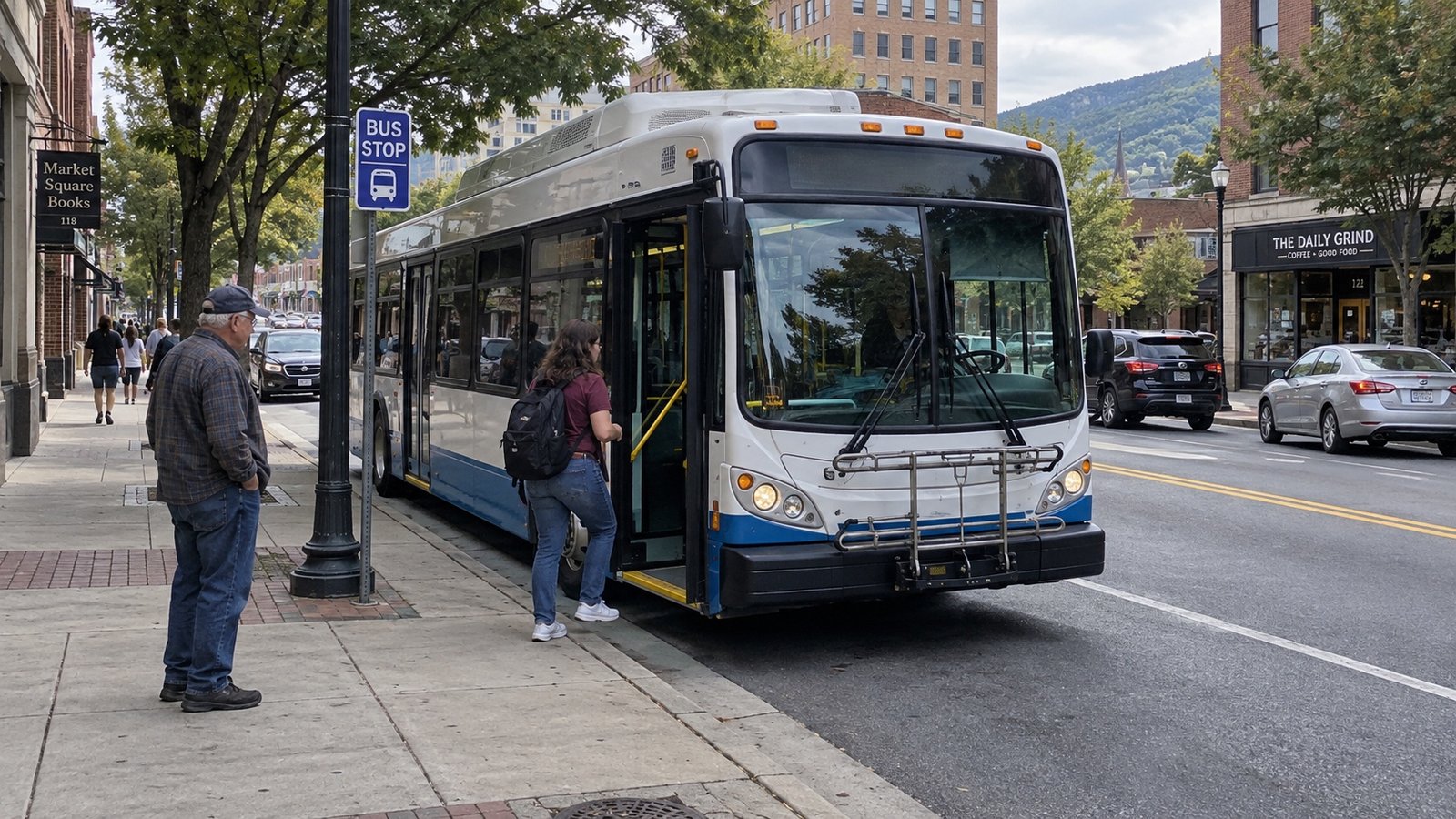 Woman beside an open city-bus door at the sidewalk while another passenger waits behind her.