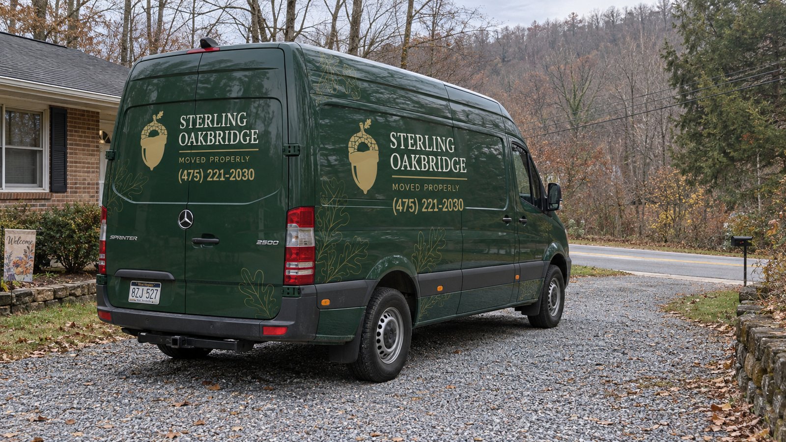 Agree the vehicle position A whole green Sterling Oakbridge Sprinter on a gravel driveway turnout beside a brick house.
