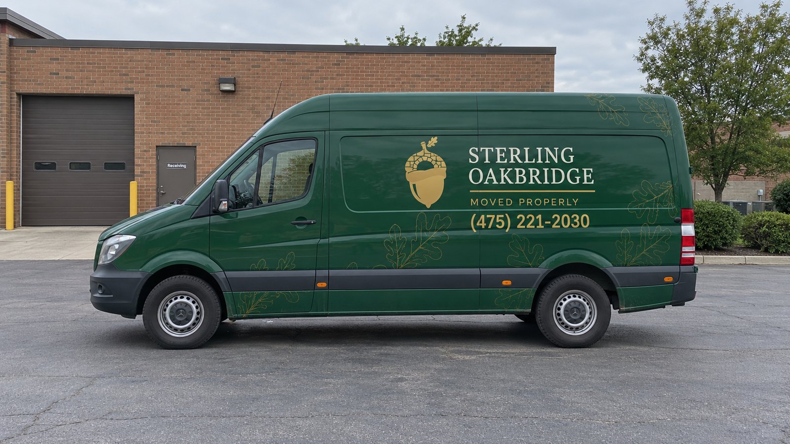 Plan for the actual vehicle A complete green Sterling Oakbridge Sprinter van standing on a paved service court beside a brick building.