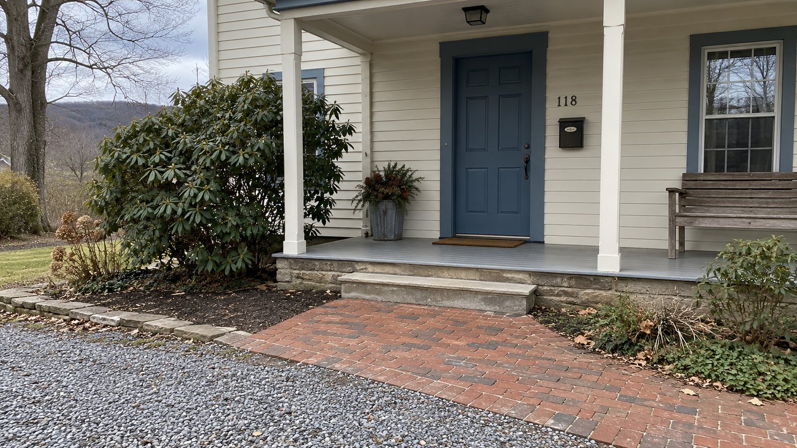 The complete receiving approach A closed blue exterior door above a covered porch landing, with a shallow step and brick approach.