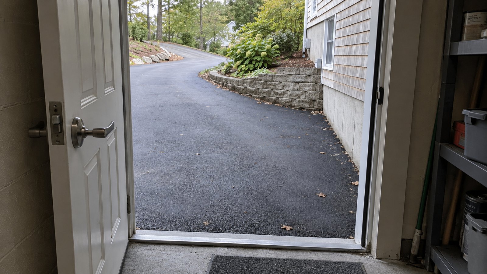 Checking a lower-level entrance Open lower-level doorway leading onto a paved driveway