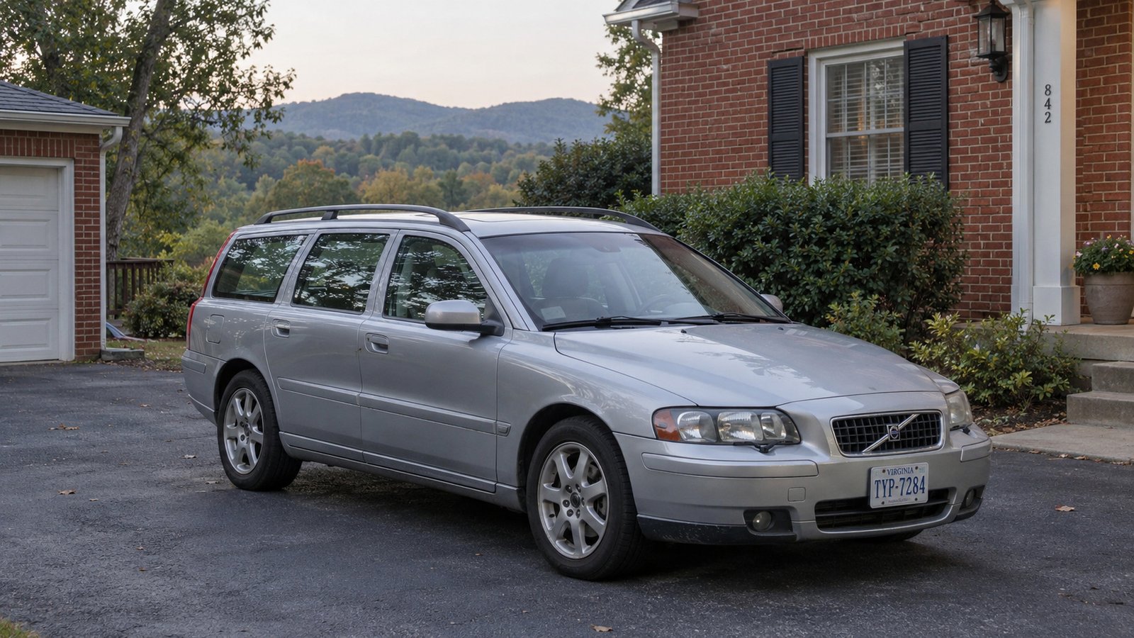 The journeys in an ordinary week Silver station wagon parked on a private paved driveway beside a brick house with wooded hills beyond