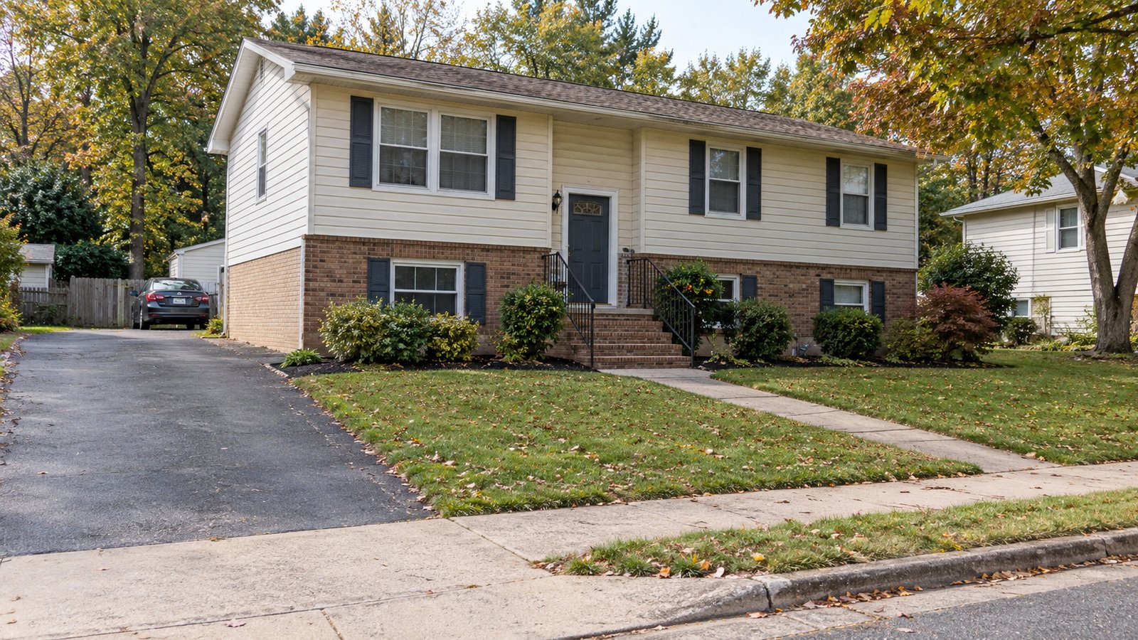 Include the front steps beyond the driveway A split-foyer house with a driveway and a separate front path leading to supported steps and one entrance door.