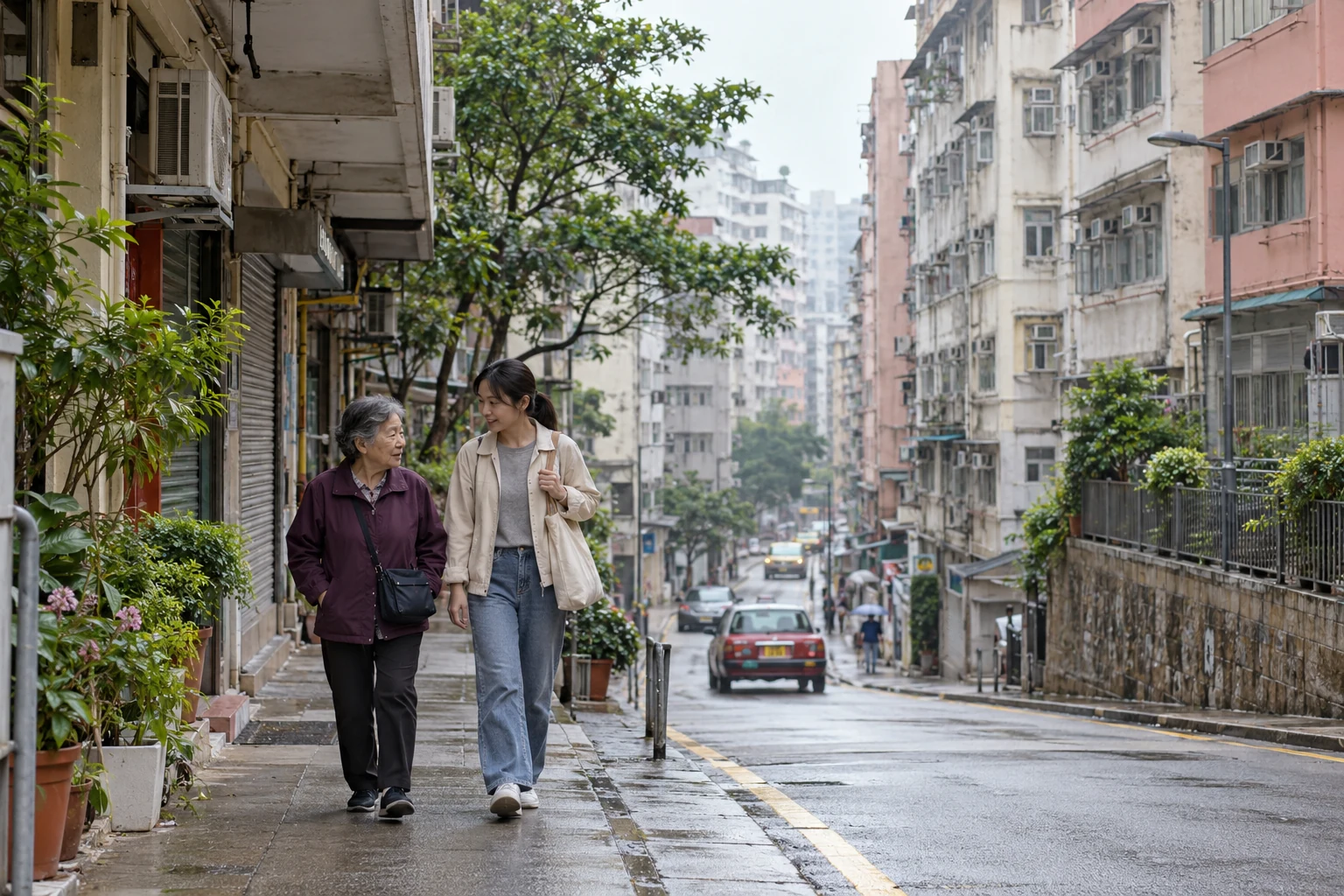 A Hong Kong neighborhood day of your own Two women walk on a narrow continuous sidewalk beside mid-rise apartment buildings on a damp urban street.