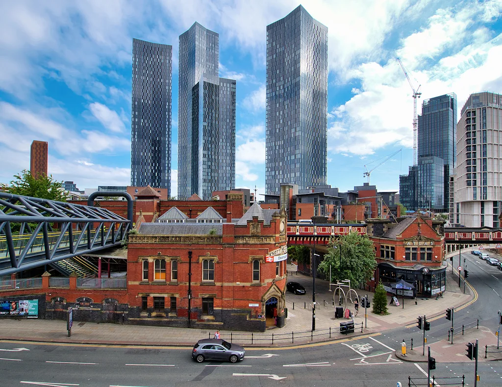 Manchester The four new tower blocks built around Deansgate Square dominate the skyline. Their 21st century design contrasting with the nineteenth century architecture of the Knott Mill (now Deansgate) Station (a Grade II listed building).